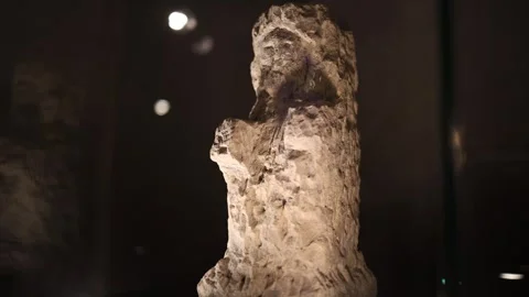 An ancient stone icon displayed in a dimly lit museum exhibit. The craftsmanship Stock Footage 294787017