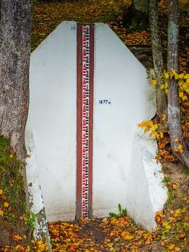 Ancient stone with a meter river level measuring station 库存照片