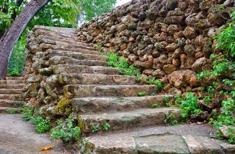 Ancient stone path stairs made of wild stone in a hilly park. Stock Photos