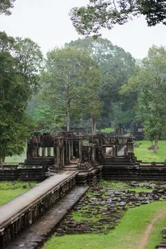 Ancient Stone Pathway Leading Through Jungle Ruins in Angkor, Cambodia Stock Photos
