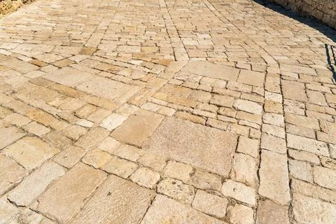 Ancient stone pavement with irregular limestone blocks and cobblestone pattern, Stock Photos