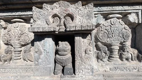 Ancient stone relief panels display carved guardian figures and mythologica.. Stock Footage 341542711