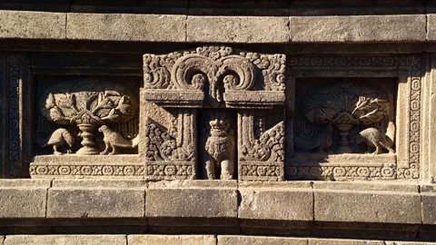Ancient stone relief panels display carved figures and decorative guardians.. Video stock 341544015