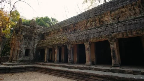 Ancient stone ruins of ta prohm temple in cambodia. Beautiful warm sunlight Stock Footage 325070616