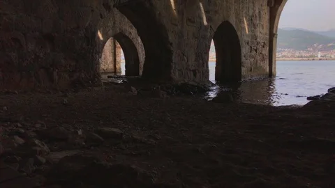 Ancient stone shipyard with access to the open sea. Stone arches and walls Stock Footage 120537853