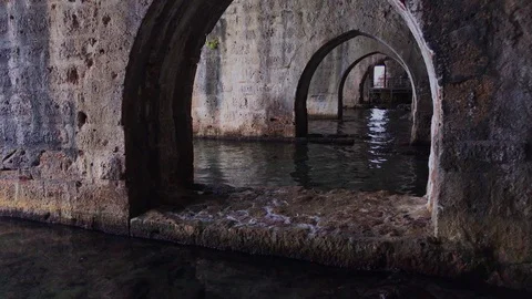 Ancient stone shipyard with access to the open sea. Stone arches and walls Stock Footage 120537909