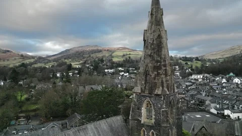 Ancient stone spire rises above quaint village rooftops Stock Footage 345654719