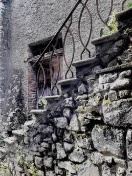 Ancient stone staircase with rusty railing 写真素材