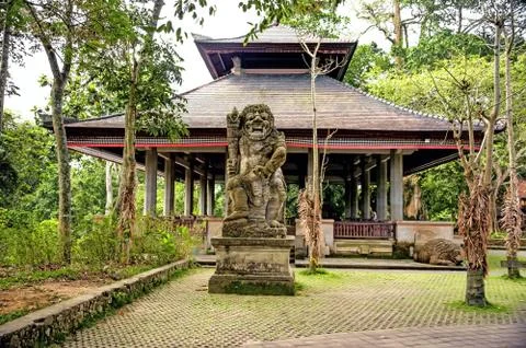 Ancient stone statue of an ancient deity on the island of Bali in a tropica.. Stock Photos