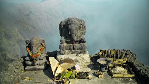 Ancient stone statue of Ganesha stands on a top of volcano Bromo Stock Footage 253649816
