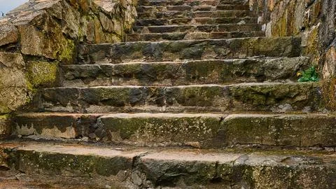 Ancient stone steps covered in moss and vegetation Stock Photos