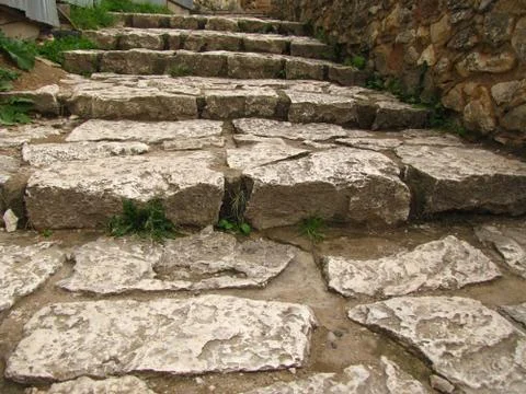 Ancient stone steps paved with stone. Stock Photos