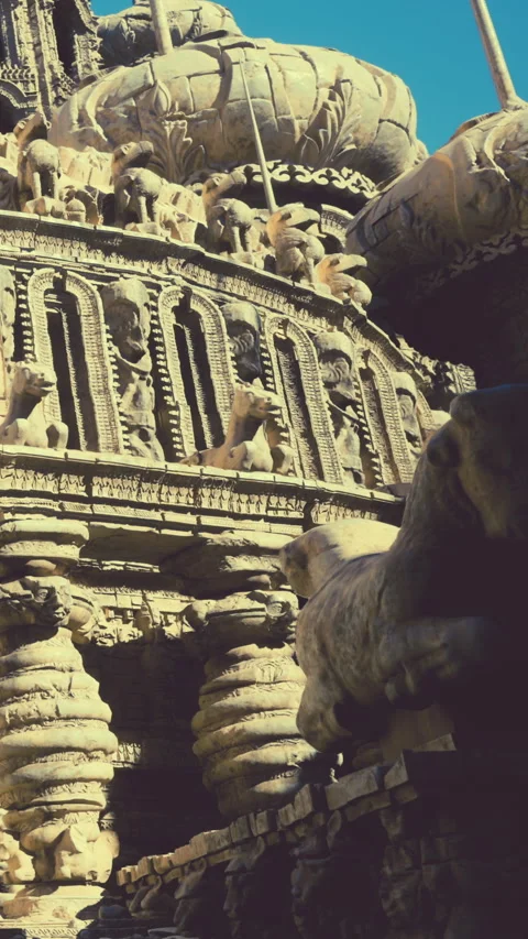 Ancient stone structure with animal carvings in bright sunlight outside Stock Footage 340280793