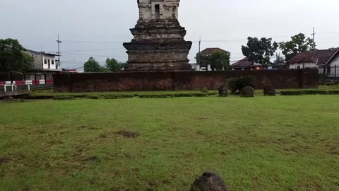 Ancient stone structure called Candi Jawi during the rainy season Video stock 279540759