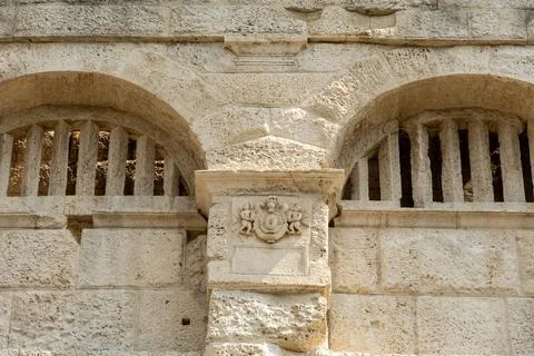 Ancient stone structure features arched openings and decorative elements, s.. Stock Photos