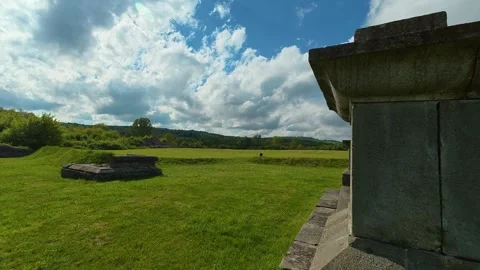 Ancient stone structure stands in sunlit meadow. Felix Romuliana, Jupiter Temple Stockbeeldmateriaal 335298846