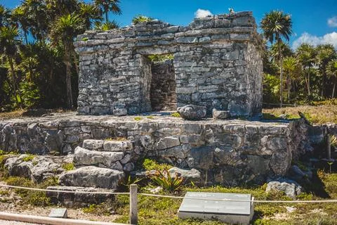 Ancient stone structure in Tulum showing ruins amidst tropical vegetation u.. Stock Photos