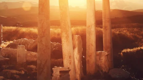 Ancient stone structure under sunset with hills in the background Stock Footage 339868818