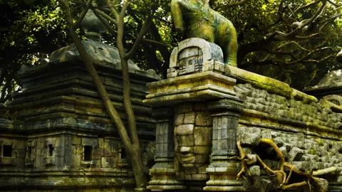 Ancient stone structures with elephant sculpture in a dense forest Stock Footage 344374185