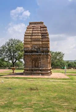 Ancient stone temple monument &amp; tree at Pattadakal , Karnataka, India. Stock Photos