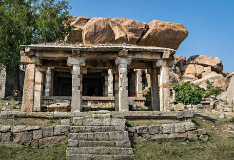 Ancient stone temple in solid rocks on hill in Hampi, Karnataka, India. Stock Photos