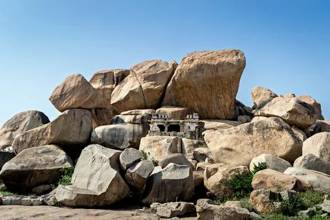 Ancient stone temple in solid rocks on hill in Hampi, Karnataka, India. Stock Photos