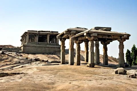 Ancient stone temple in solid rocks on hill in Hampi, Karnataka, India. Stock Photos