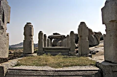 Ancient stone temple in solid rocks on hill in Hampi, Karnataka, India. Stock Photos