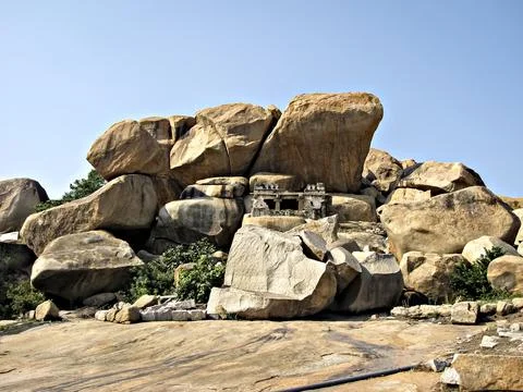 Ancient stone temples in solid rocks on hill in Hampi, Karnataka, India. Stock Photos