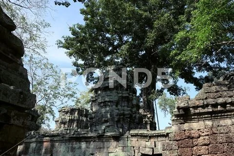 Ancient stone tower of an abandoned temple complex in Southeast Asia. Stock Photos