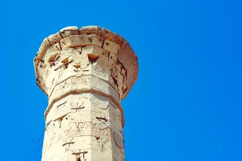 An ancient stone tower on a blue sky background Stock Photos