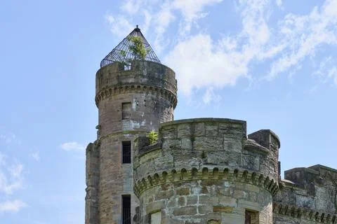 Ancient stone tower rises against bright blue sky Stock Photos