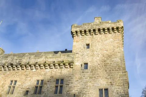 Ancient stone tower rises against blue sky Stock Photos