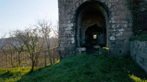 Ancient stone tower ruins on a grassy hill Stock Footage 336482890