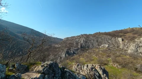 Ancient stone tower stands tall against clear blue sky. Mount Ozren Видео 330958747