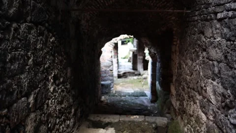 Ancient stone tunnel with light exit Stock Footage 328968915