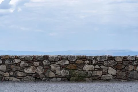 Ancient stone wall against the background of the sky Stock Photos