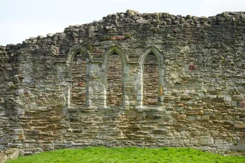 Ancient Stone Wall With Arched Windows At Basingwerk Abbey Ruins, North Wales. 库存照片