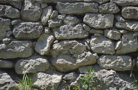 Ancient stone wall. Background of old vintage stone wall. High quality photo Stock Photos