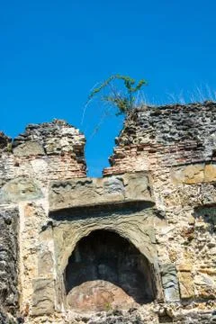 Ancient stone wall on blue sky background. Stock Photos