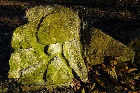 Ancient Stone Wall Composed of Textured Boulders, Showcasing Natural Moss G.. Stock Photos