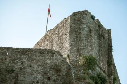 Ancient stone wall with flag 스톡 사진