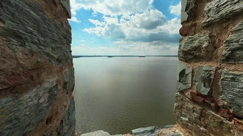 Ancient stone wall frames calm river below. Ram Fortress, Serbia Видео 332544245