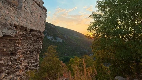 Ancient stone wall frames sunlit valley. Soko Grad, Serbia 動画素材 345897227