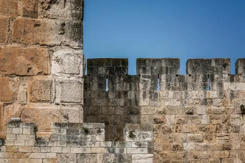Ancient Stone Wall of Jerusalem Old City Against a Clear Blue Sky Stock Photos