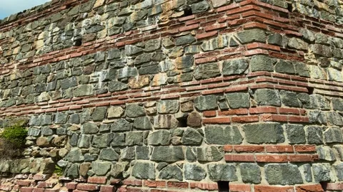 Ancient stone wall rises under bright blue sky. Felix Romuliana, Gamzigrad. Stock Footage 335298501