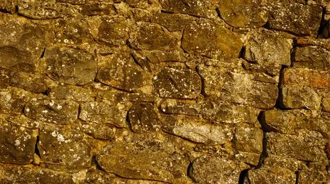 Ancient stone wall at sunset Foto stock