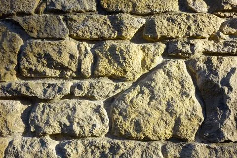 Ancient Stone Wall Texture Composed of Boulders in a Rustic Setting During .. Stock Photos