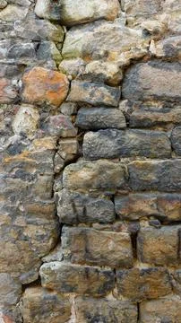 Ancient Stone Wall Texture Featuring Uneven Stones and Weathered Appearance Stock Photos