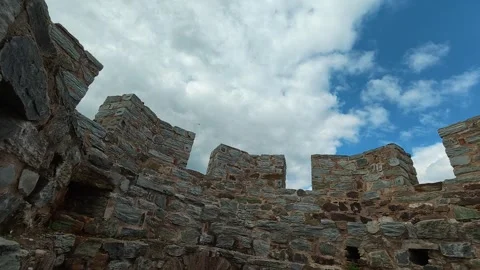 Ancient stone walls stand under a bright blue sky. Ram Fortress, Serbia Vidéo 332543924